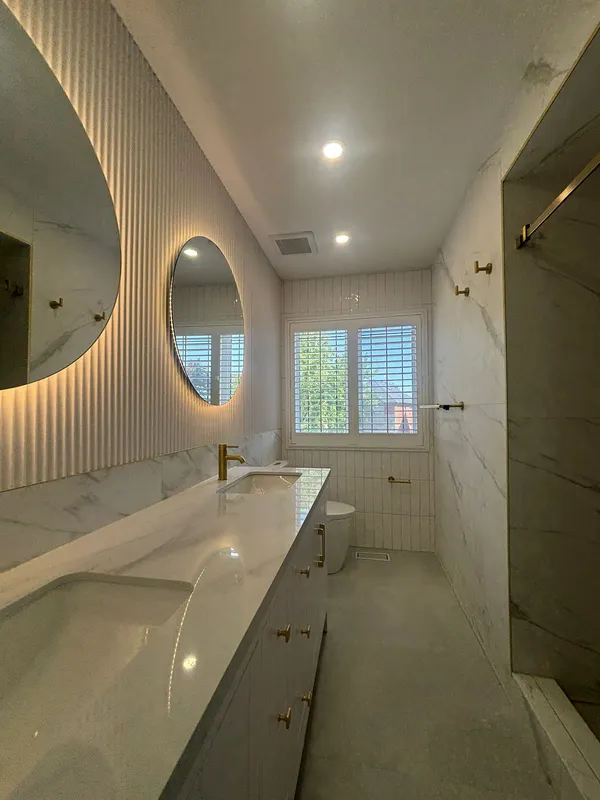 Contemporary bathroom marble tile gold accents